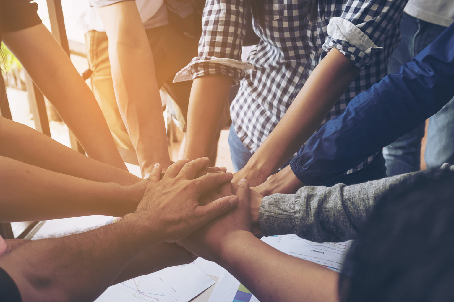 Business people join hand together during their meeting